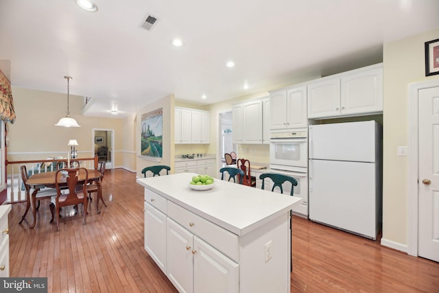 10017 Prestwich Ter, Ijamsville, MD 21754 - kitchen featuring white appliances, light wood-style flooring, a center island, white cabinetry, and recessed lighting