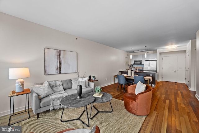 2101 Market St Unit 705, Philadelphia, PA 19103 - living room featuring baseboards and dark wood-type flooring