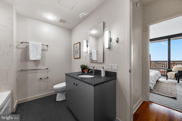 2101 Market St Unit 705, Philadelphia, PA 19103 - bathroom with vanity, toilet, baseboards, and visible vents