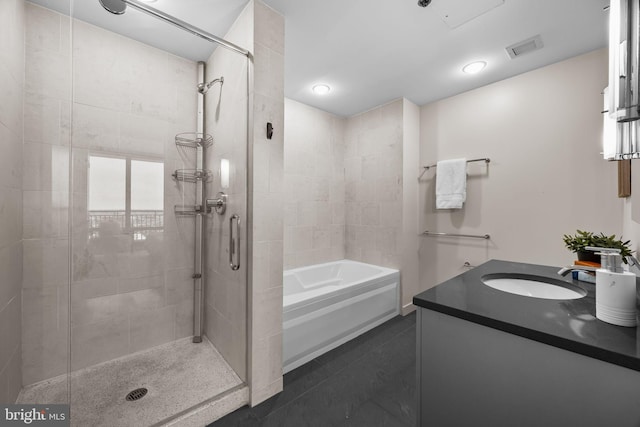 2101 Market St Unit 705, Philadelphia, PA 19103 - bathroom with vanity, visible vents, tile patterned floors, a stall shower, and a garden tub