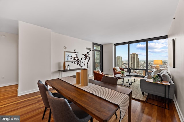 2101 Market St Unit 705, Philadelphia, PA 19103 - dining space with baseboards, plenty of natural light, and wood finished floors