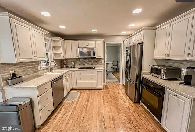 1448 Laurel Hill Rd, Vienna, VA 22182 - kitchen with black appliances, light wood-style flooring, recessed lighting, backsplash, and open shelves