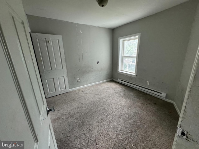 unfurnished bedroom featuring a baseboard radiator and carpet floors