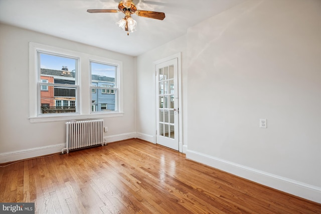 1362 Sheridan St NW, Washington, DC 20011 - unfurnished room featuring radiator, light wood finished floors, and ceiling fan