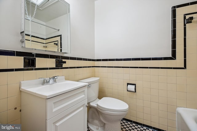 1362 Sheridan St NW, Washington, DC 20011 - bathroom with tile walls, vanity, a bathtub, and a wainscoted wall