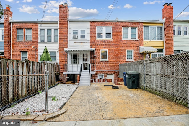 1362 Sheridan St NW, Washington, DC 20011 - back of property featuring a fenced backyard, brick siding, and a chimney