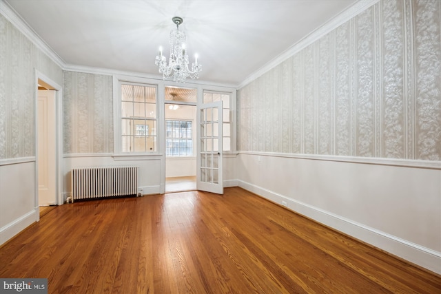 1362 Sheridan St NW, Washington, DC 20011 - unfurnished dining area featuring radiator heating unit, a chandelier, wood finished floors, wallpapered walls, and ornamental molding