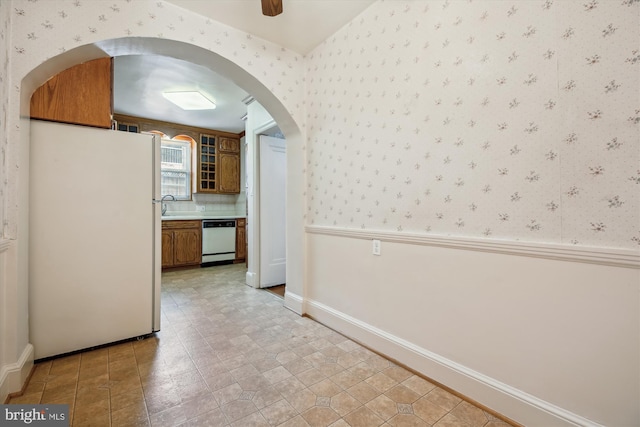 1362 Sheridan St NW, Washington, DC 20011 - unfurnished dining area featuring wallpapered walls, arched walkways, and ceiling fan