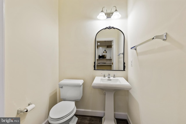 3745 Signal Knob Ct, Falls Church, VA 22041 - half bath with toilet, baseboards, and wood finished floors