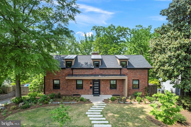 3175 21st St N, Arlington, VA 22201 - tudor house featuring brick siding, a chimney, fence, and a front yard