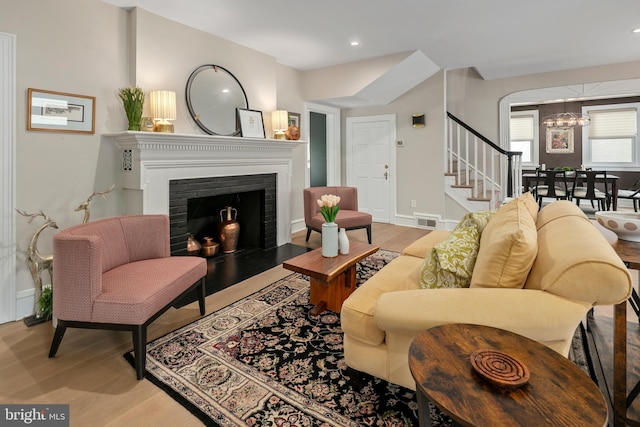 3175 21st St N, Arlington, VA 22201 - living area with stairway, a notable chandelier, visible vents, and wood finished floors