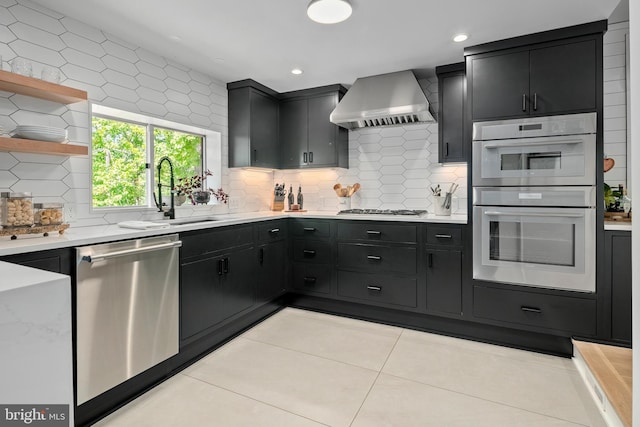 3175 21st St N, Arlington, VA 22201 - kitchen featuring dark cabinetry, stainless steel appliances, a sink, and wall chimney exhaust hood