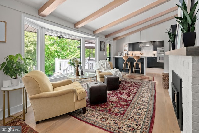 3175 21st St N, Arlington, VA 22201 - living area featuring light wood finished floors, lofted ceiling with beams, and a healthy amount of sunlight