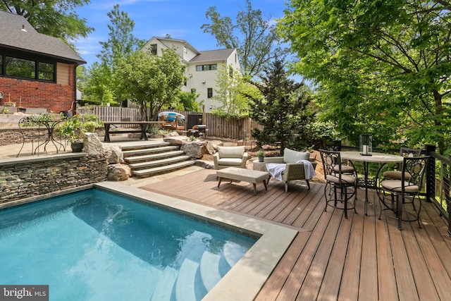 3175 21st St N, Arlington, VA 22201 - pool featuring a fenced backyard, a wooden deck, and outdoor dining space