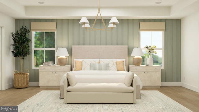 bedroom featuring a chandelier, baseboards, wallpapered walls, and wood finished floors