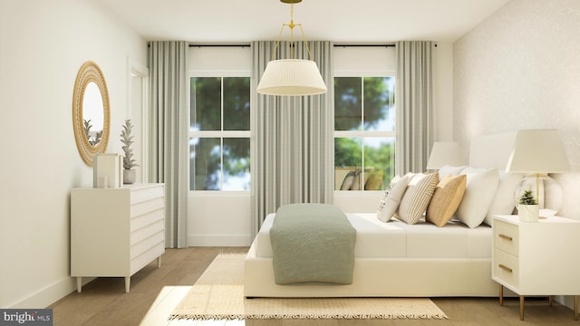 bedroom featuring baseboards and wood finished floors