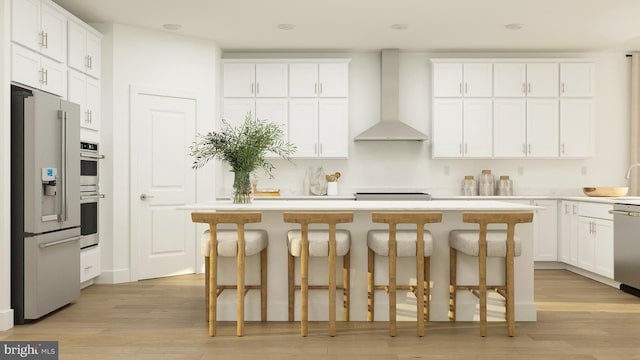 kitchen with white cabinetry, wall chimney range hood, and stainless steel appliances