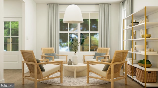 sitting room featuring plenty of natural light and wood finished floors