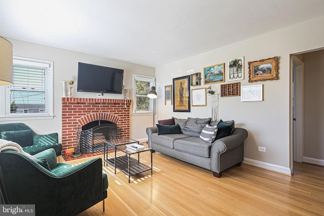 6226 Long Meadow Dr, Sykesville, MD 21784 - living room with light wood-style floors, baseboards, and a brick fireplace