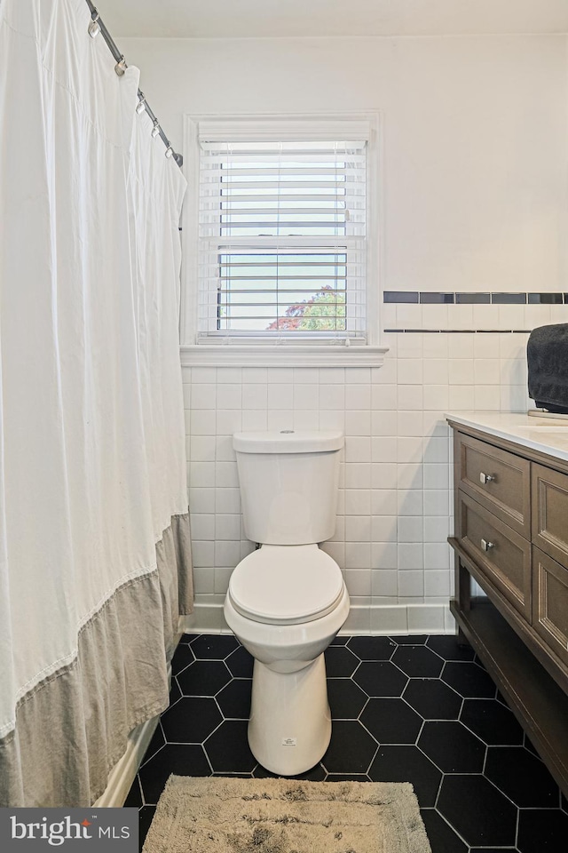 6226 Long Meadow Dr, Sykesville, MD 21784 - bathroom featuring tile patterned flooring, tile walls, toilet, wainscoting, and vanity
