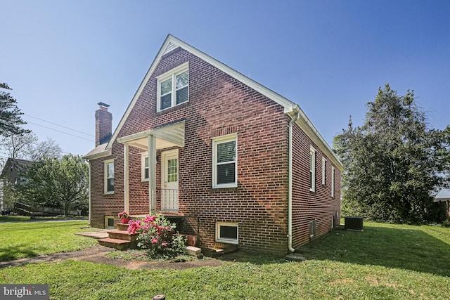 6226 Long Meadow Dr, Sykesville, MD 21784 - view of front of house featuring brick siding, a chimney, a front lawn, and central AC