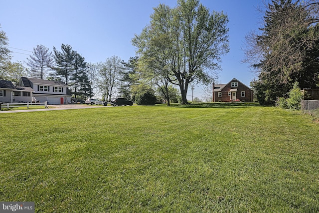 6226 Long Meadow Dr, Sykesville, MD 21784 - view of green lawn featuring an attached garage and driveway