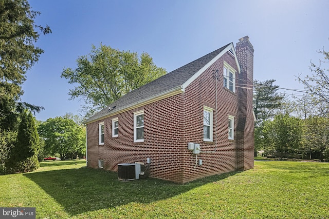 6226 Long Meadow Dr, Sykesville, MD 21784 - view of side of home with a chimney, a lawn, brick siding, and cooling unit