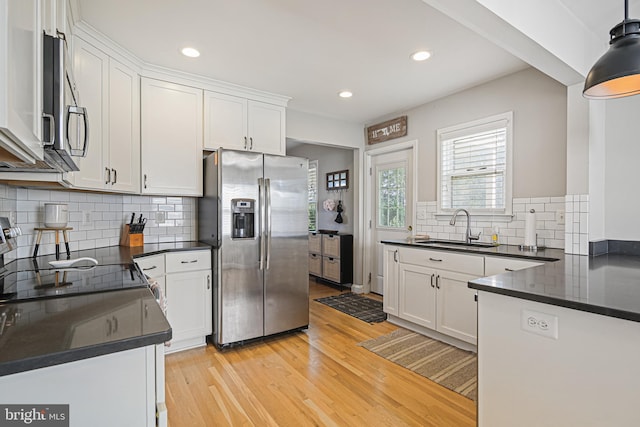 6226 Long Meadow Dr, Sykesville, MD 21784 - kitchen with stainless steel appliances, a sink, dark countertops, light wood-style floors, and recessed lighting