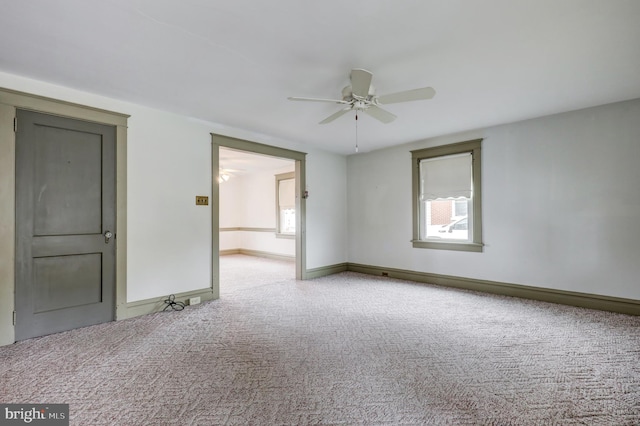 spare room featuring carpet flooring, a ceiling fan, and baseboards