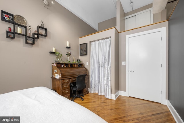 bedroom featuring baseboards and wood finished floors
