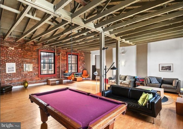 rec room featuring brick wall, billiards, and wood finished floors