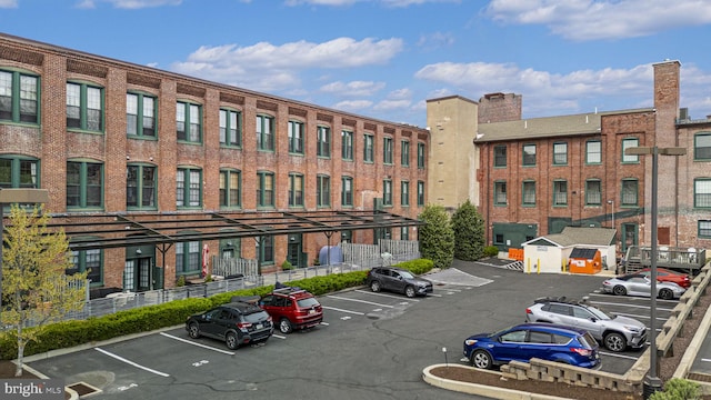 view of building exterior with uncovered parking