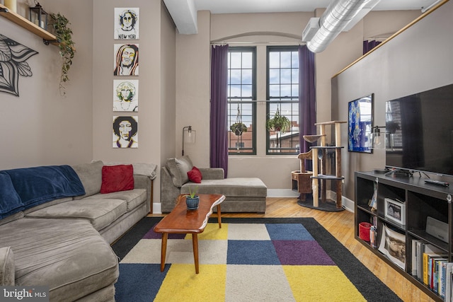 living room with baseboards and wood finished floors