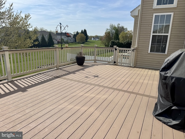 wooden terrace featuring a yard
