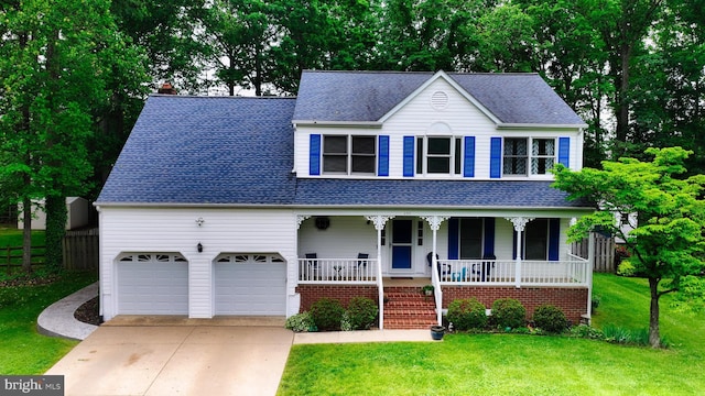 view of front of property with a porch, concrete driveway, a shingled roof, and a garage