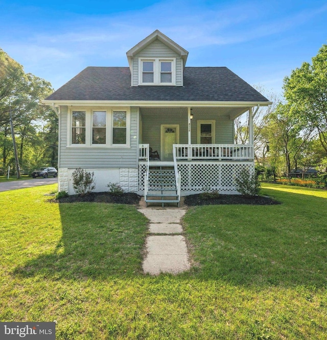 bungalow-style home featuring a front lawn, a porch, and roof with shingles