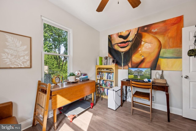 office area with baseboards, wood finished floors, and a ceiling fan