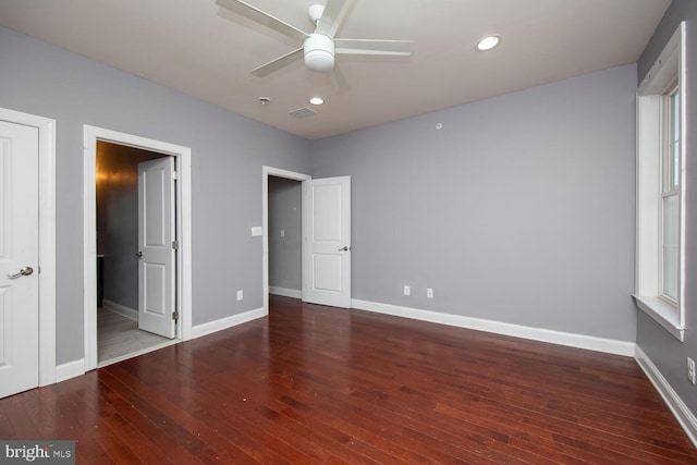 unfurnished bedroom with hardwood / wood-style flooring, baseboards, visible vents, and recessed lighting