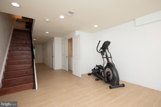 exercise area featuring light wood-style floors, baseboards, visible vents, and recessed lighting