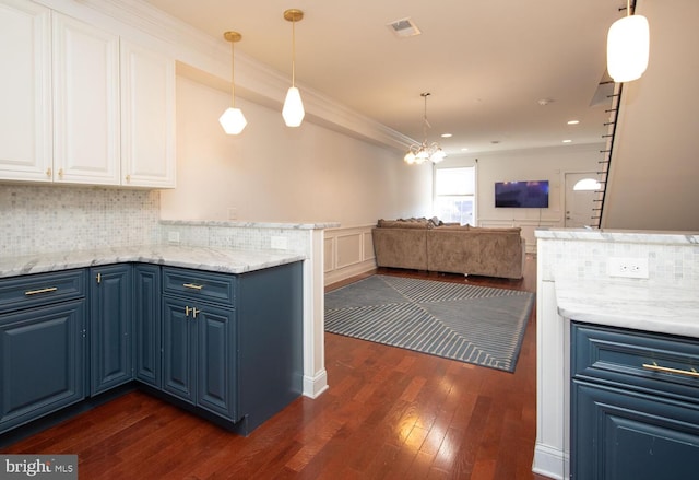 kitchen with blue cabinets, dark wood finished floors, crown molding, a chandelier, and white cabinetry