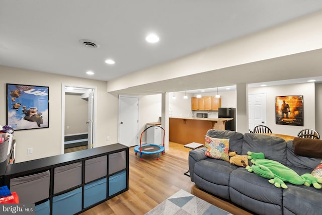100 Lucy Long Ct, Stephens City, VA 22655 - living room featuring light wood-style floors, recessed lighting, and bar area