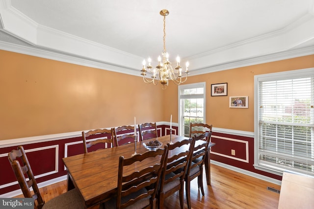 100 Lucy Long Ct, Stephens City, VA 22655 - dining space with wainscoting, crown molding, a raised ceiling, light wood finished floors, and a chandelier
