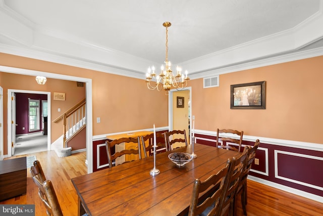 100 Lucy Long Ct, Stephens City, VA 22655 - dining area featuring a raised ceiling, a chandelier, wood finished floors, crown molding, and wainscoting