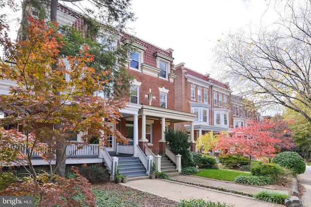 1613 Harvard St NW Unit 105, Washington, DC 20009 - multi unit property featuring brick siding, covered porch, mansard roof, and stairway