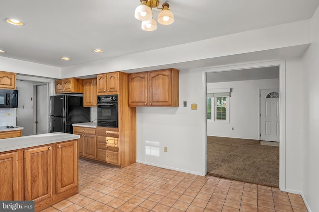 kitchen with black appliances, a chandelier, light countertops, light carpet, and recessed lighting