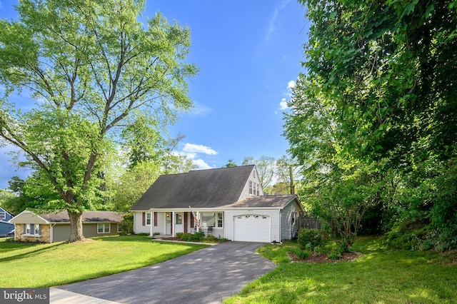 new england style home with a garage, driveway, and a porch