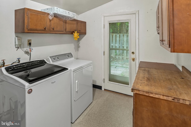 laundry room featuring cabinet space, separate washer and dryer, and light floors