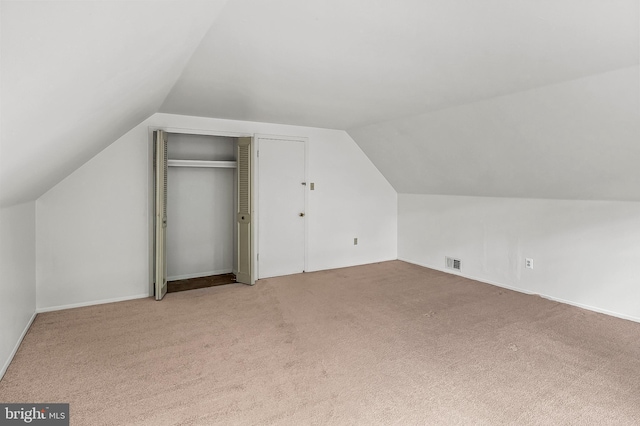 bonus room featuring vaulted ceiling, carpet, and baseboards