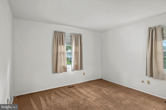 carpeted spare room with baseboards