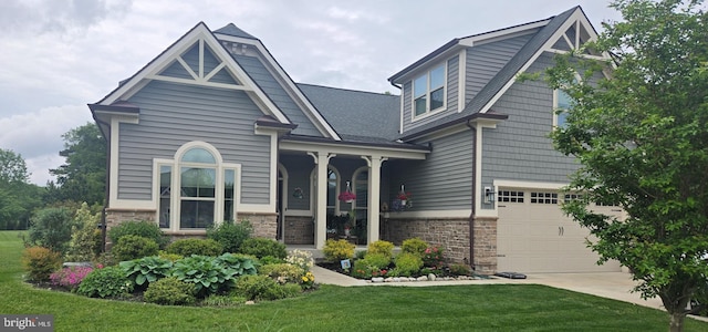 23593 Robalo Rd, Frankford, DE 19945 - view of front of house with an attached garage, stone siding, and a front yard